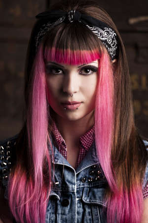 Portrait of a young punk girl with a nice hair cut in pink
