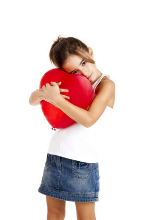 Portrait of a little girl embracing a red balloon, isolated on white backgroundの写真素材