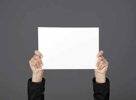 Woman holding a blank paper sheet with both hands
