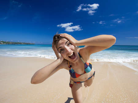 Beautiful and happy young woman  enjoying the summer on a tropical beach の写真素材