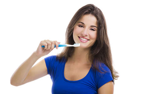 Beautiful woman with a great smile holding toothbrush, isolated over a white backgroundの写真素材