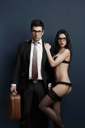 Business man and a sexy young woman in lingerie. Concept about work and pleasureの写真素材