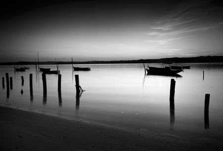 Beautiful landscape of a river and boats at sunsetの写真素材