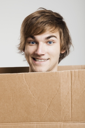 Portrait of a handsome young man inside a cardboxの写真素材