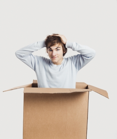 Portrait of a handsome young man inside a cardbox