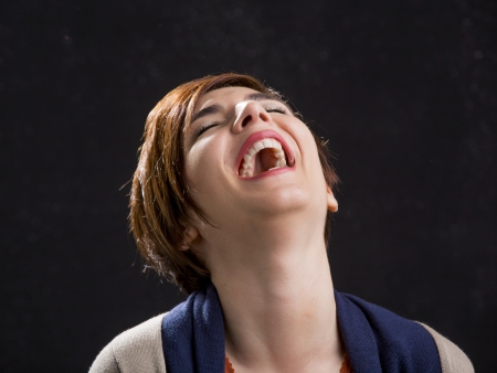 Portrait of a beautiful and happy woman laughing with a modern hair cutの写真素材