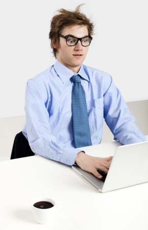 Young man in the office working in the laptopの写真素材