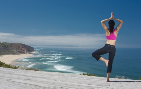 Beautiful young woman in outdoor doing yogaの写真素材