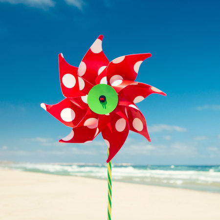 Red windmill with a beach as a backgroundの写真素材