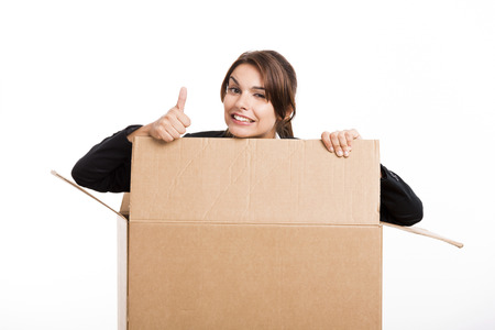 Business woman appear inside a big card box with thumbs up, isolated over white background 