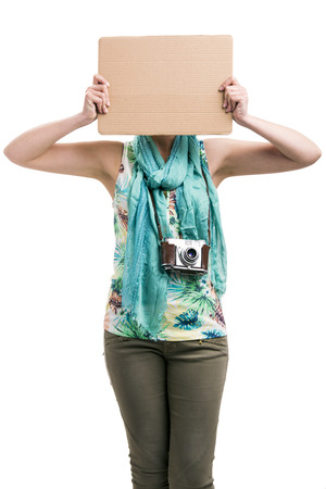 Beautiful woman holding a cardboard, isolated over a white backgroundの写真素材
