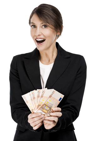 Happy business woman holding euro currency notes, isolated over a white backgroundの写真素材