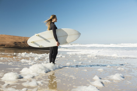Teenage surfer girl checking the wavesの写真素材