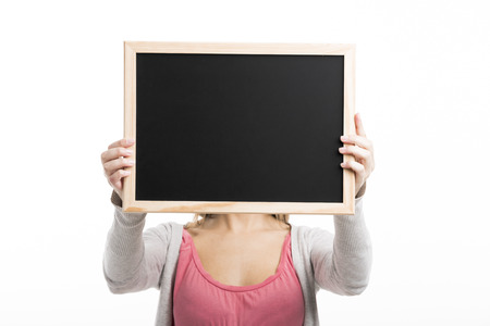 Beautiful woman holding  a chalkboard, isolated over white backgroundの写真素材