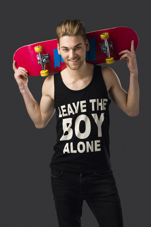 Studio portrait of a young man posing with a skateboardの写真素材