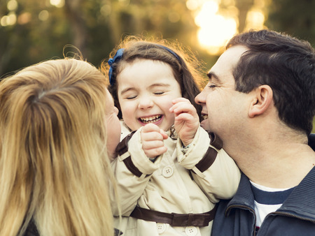 Outdoor portrait of a happy family enjoying the fall seasonの写真素材