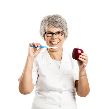 elderly woman brushing teethの写真素材