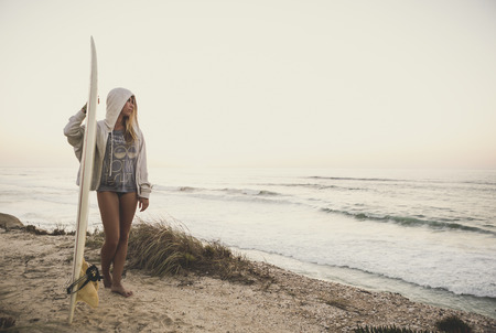 Beautiful female Surfer looking for the wavesの写真素材