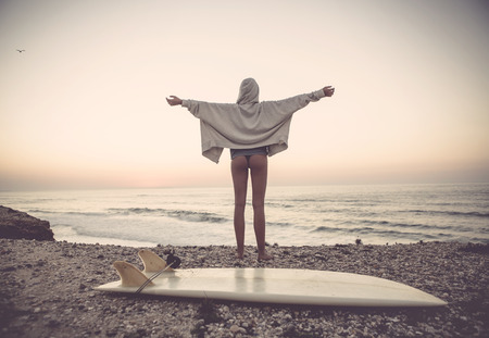 Beautiful female Surfer looking for the waves