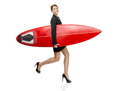 Business woman holding a surfboard, isolated on white backgroundの写真素材