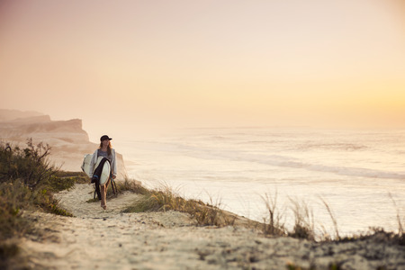 Beautiful female Surfer looking for the waves