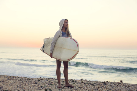 Beautiful female Surfer looking for the waves