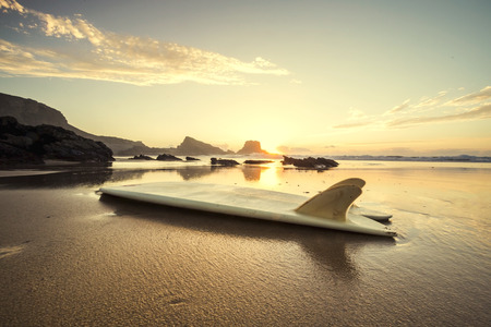 Silhouette of a surfboard at the beach with reflectionの写真素材