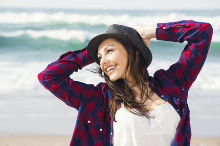 Beautiful and happy teen at the beach enjoying the summerの写真素材