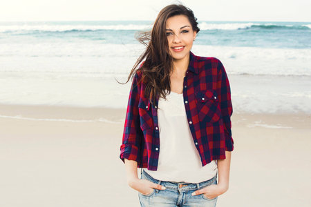 Beautiful and happy teen at the beach enjoying the summerの写真素材