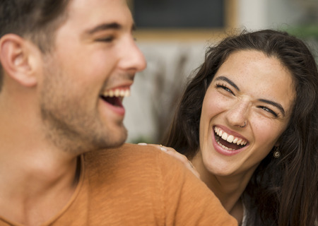 Happy couple at the restaurant talking and smilingの写真素材