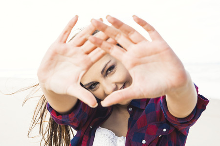 Beautiful and happy teen at the beach enjoying the summerの写真素材