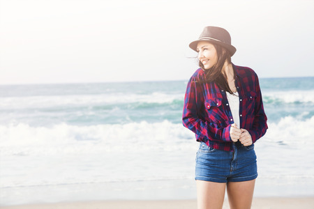 Portrtait of a happy girl enjoying the day on the beachの写真素材