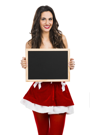 Beautiful and sexy Santa Girl holding a small chalkboard on her handsの写真素材