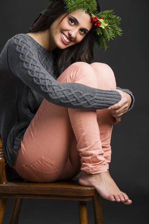 Portrait of a beautiful woman with Cristmas decorations on the headの写真素材
