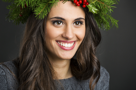Portrait of a beautiful woman with Cristmas decorations on the headの写真素材