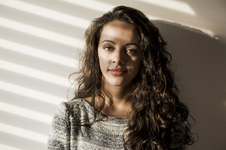 Portrait of a beautiful woman on her bedroomの写真素材