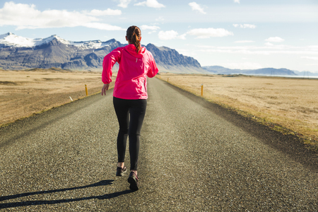 Shot of a beautiful woman running in a beautiful afternoonの写真素材