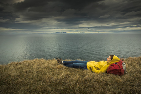 Female backpacker tourist in Icleand resting after a long day of adventures