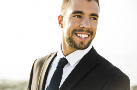 Good look young man in outdoor wearing a suit and smilingの写真素材