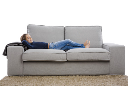 Little girl lying on a couch and resting