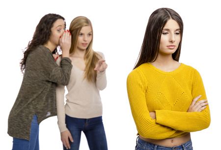 Teenagers making gossip from other girlの写真素材