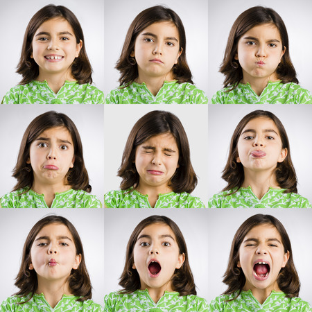 Multiple portraits of the same little girl making diferent expressionsの写真素材