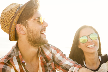 Young couple at the beach and having funの写真素材