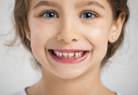 Studio portrait of a beautiful and happy girl smiling