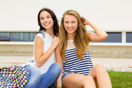 Happy teenage students in the schoolの写真素材