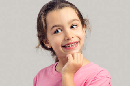 Studio portrait of a beautiful little girl thinkingの写真素材