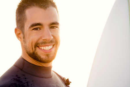 Outdoor portrait of an handsome young surfist smilingの写真素材