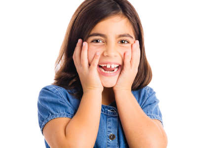 Studio portrait of a beautiful girl smiling, isolated over white backgroundの写真素材
