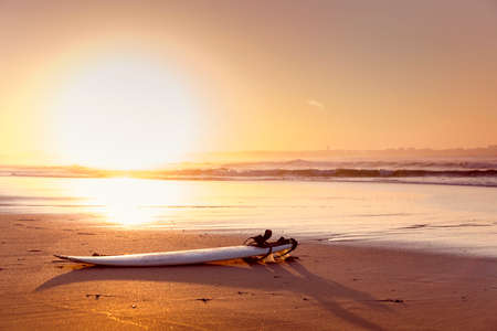 Beautiful beach lansdscape with a surfboard in the sandの写真素材