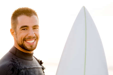 Outdoor portrait of an handsome young surfist smiling